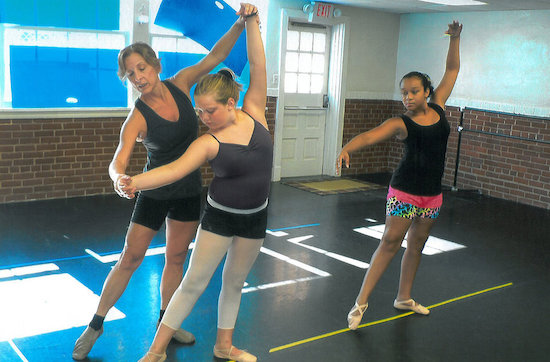 Melissa Lannom gives a lesson to dance students Sadie Leigh Perry and Zoie Shough.