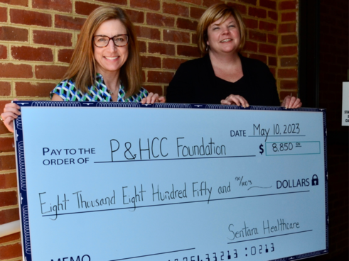 P&HCC Foundation Executive Director Tiffani Underwood presents Amy Webster, P&HCC Director of Nursing and Allied Health, a check on behalf of Sentara Cares to support qualifying P&HCC healthcare students as they pursue degrees and certifications.