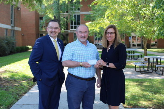 P&HCC President Greg Hodges and P&HCC Foundation Executive Director Tiffani Underwood accept a donation to support Patriot Pantry from Tim Stone of Bassett Kiwanis Club.
