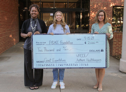 Student Success Center Coordinator Seberina Tatum and Great Expectations coach Briana Koger receive the VFCCE/Anthem donation from P&HCC Associate Vice President of Institutional Advancement and P&HCC Foundation Executive Director Tiffani Underwood.