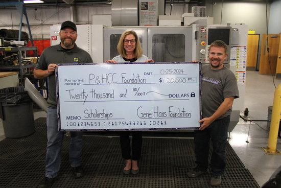 Instructors Justin Durden and Denver Smith receive a big check presented by Tiffani Underwood, P&HCC Foundation Executive Director.